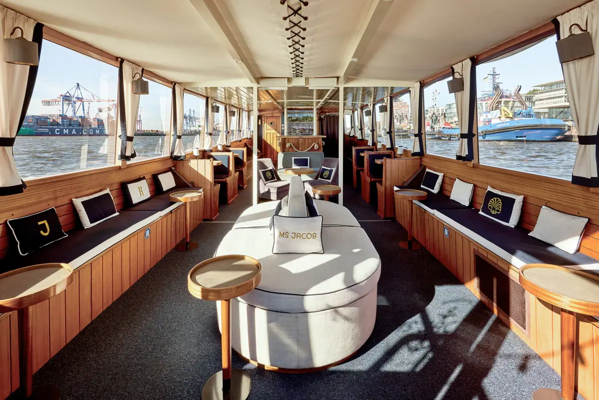 Ein Raum mit einem Sofa und Stühlen auf einem Boot.