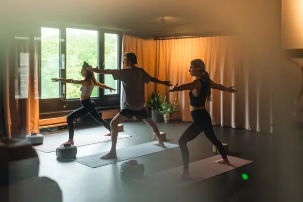 Yoga im Urban Nature St. Peter-Ording Eine Gruppe von Menschen beim Yoga auf Matten in einem Innenraum