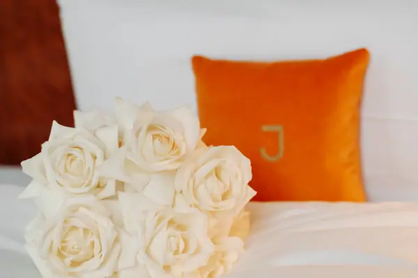 Ein Strauß weißer Rosen auf einem Bett